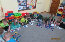 dzieci z gr. I ukladaja obrazki z plastikowych nakretek