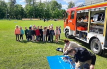 Dzieci ogladaja narzedzia strazackie