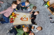 Ukladanie przez chlopcow ludzika z warzyw i owocow