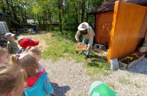 pszczelarz pokazuje dzieciom pszczoly oraz ich krolowa