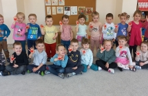 Radosne dzieci prezentuja serduszka na dloniach