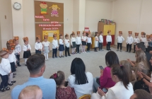 Dzieci z gr. I  w opaskach misiach stoja  przed rodzicami.