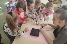 Kosmetyczka maluje dziewczynkom z gr. VI paznokcie