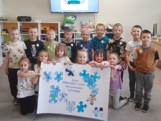 dzieci z grupy Sowki z plakatem o autyzmie
