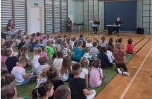 Dzieci sluchaja gry muzykow.