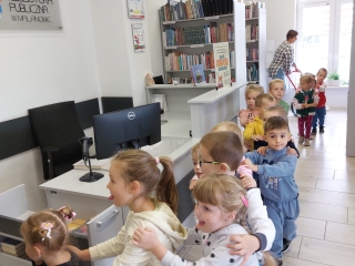 1. Dzieci ustawione w rzędzie zwiedzają bibliotekę